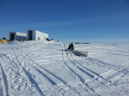 snowmachine leading to building on snowy tundra