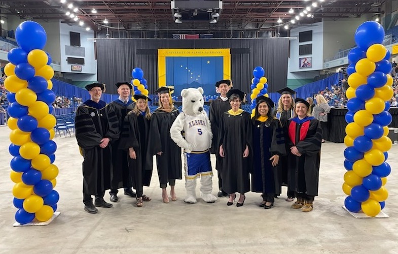 The University of Alaska Fairbanks core cabinet leadership team, including the UAF graduate school dean, pause briefly before commencement on April 30, 2022.