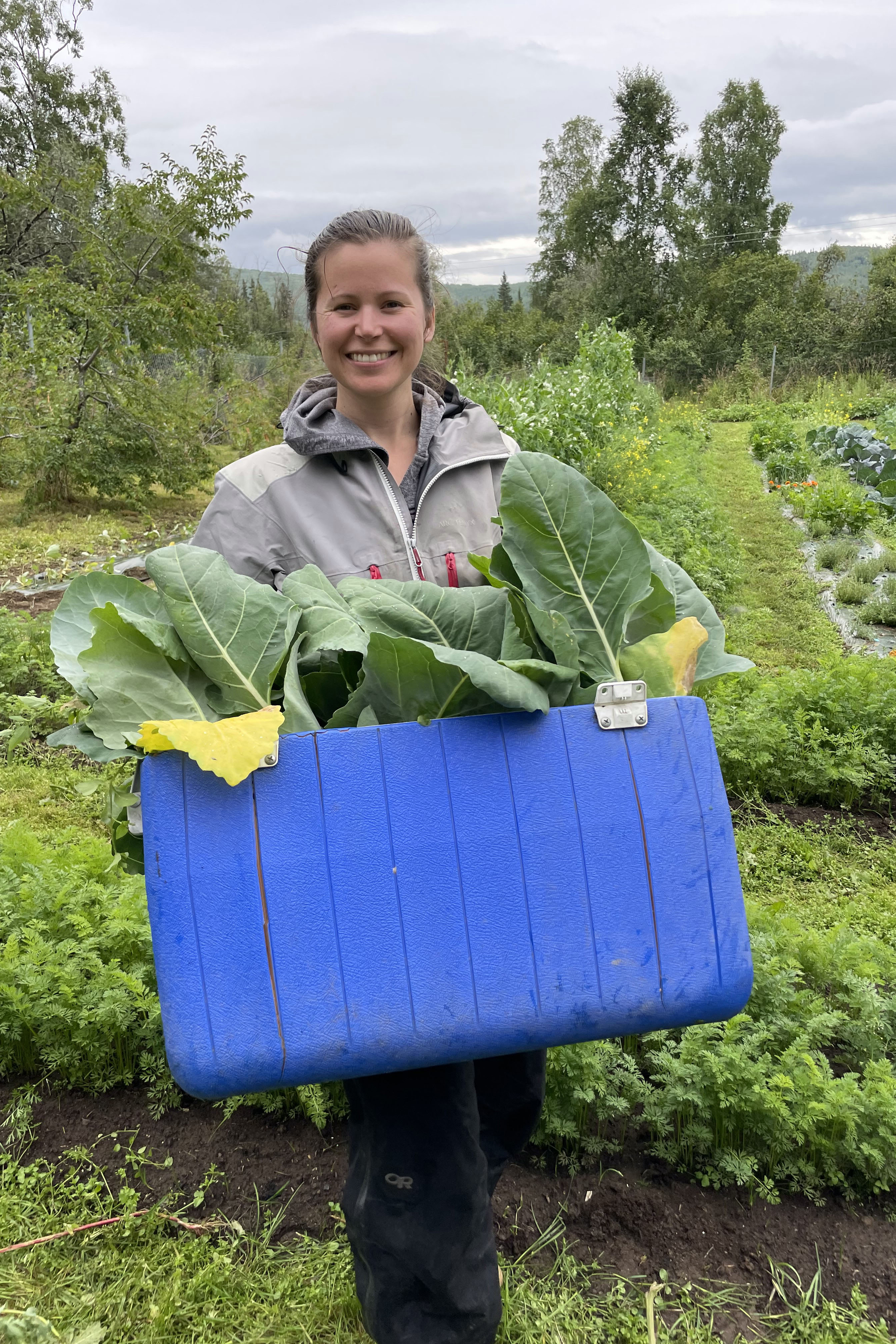 Woman with a cooler filled with produce.