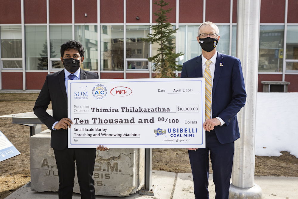 UAF Chancellor White with AIC 2021 main division winner, Thimira Thilakarathna.