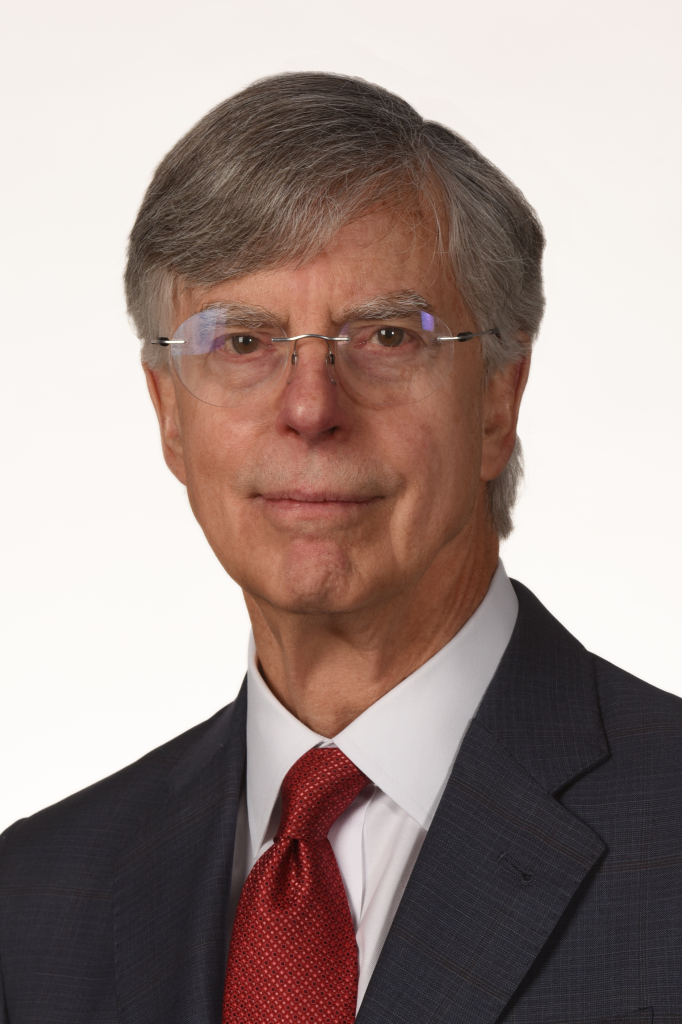 a portrait of a person in a dark suit