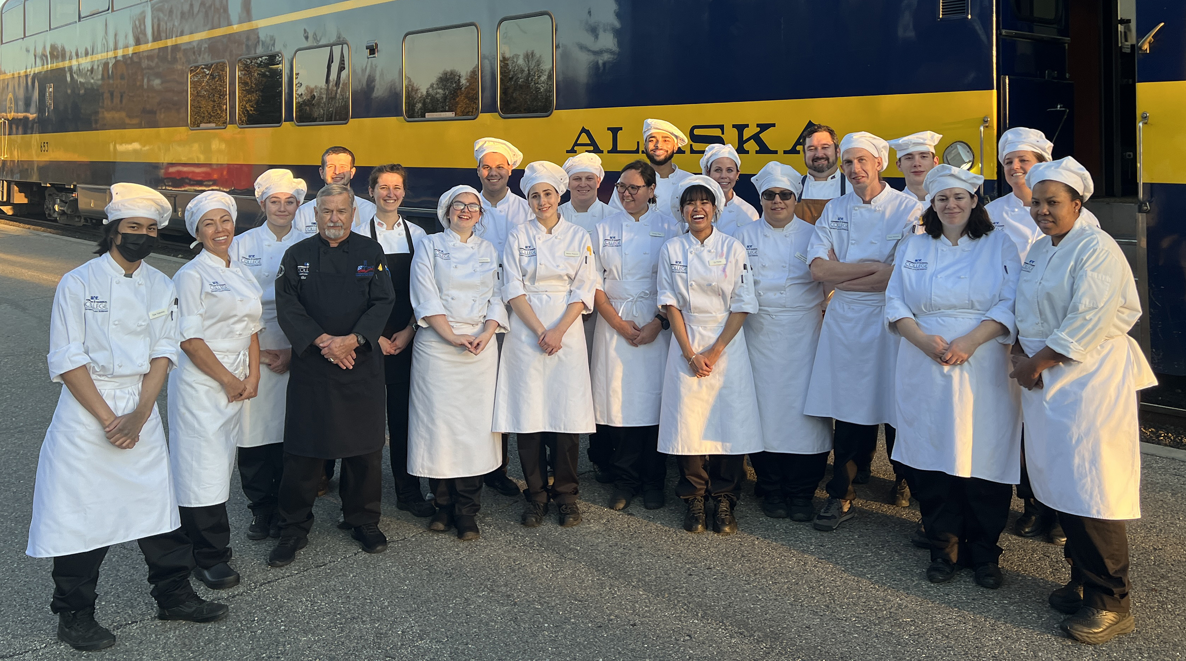 UAF Community and Technical College Culinary Arts and Hospitality staff, faculty and students gather in front of the train following the event.