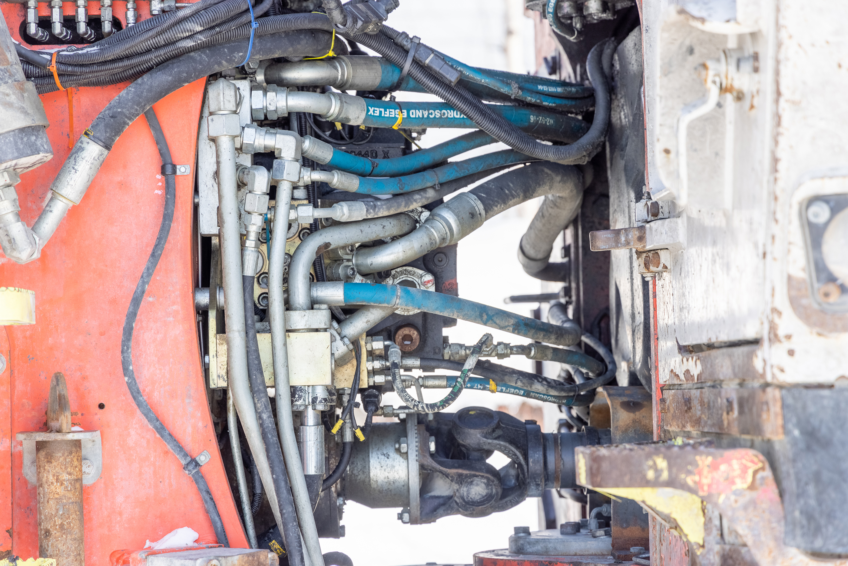 a group of blue hoses connected to two sides of a piece of equipment