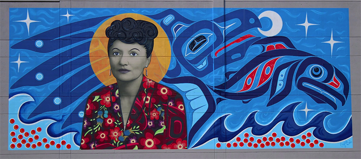 A mural commemorating Elizabeth Ḵaax̱gal.aat Peratrovich, a Tlingit civil rights activist, was created by Crystal Kaakeeyáa Rose Demientieff Worl, a Tlingit and Athabascan creator.