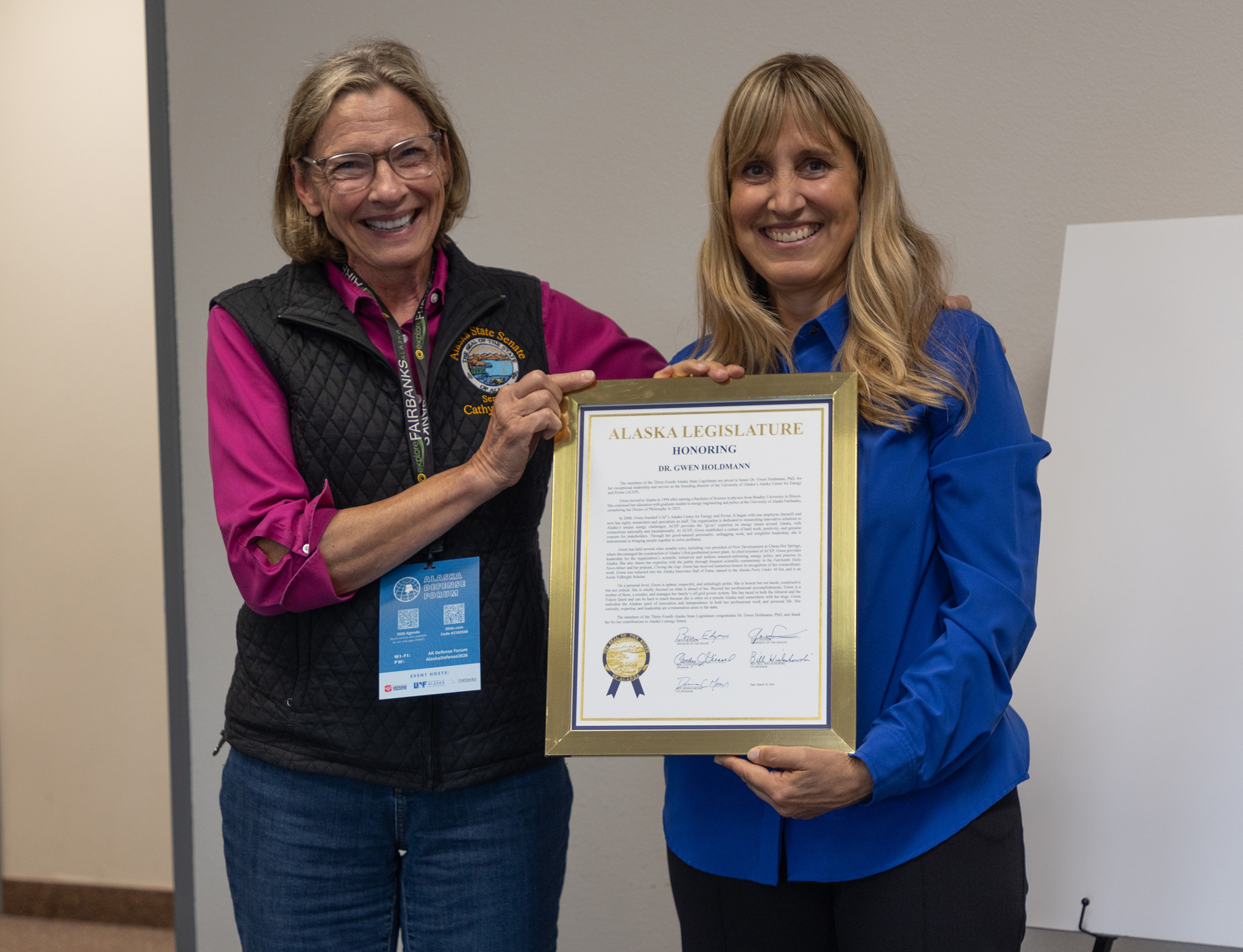 Two people holding a certificate