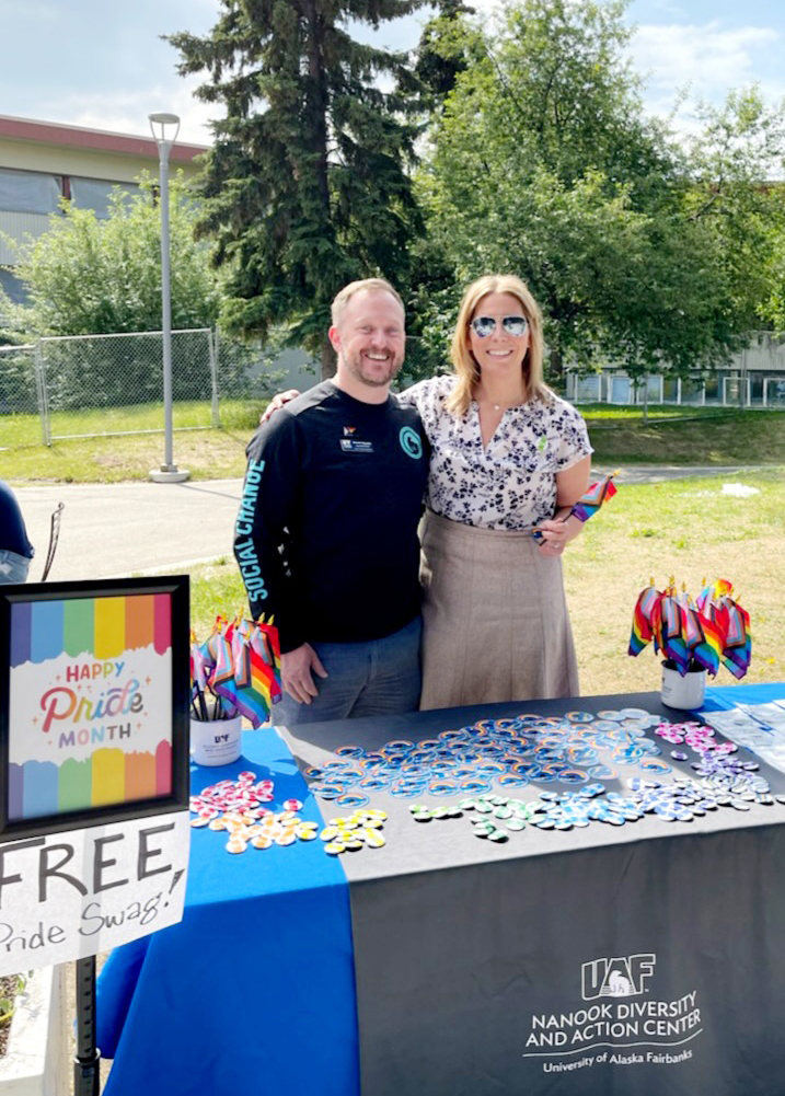 Julie Queen, UAF vice chancellor for administrative services, and Ronnie Houchin pause at the Pride Month swag and information table set up at Ice Cream Thursdays at the Wood Center on UAF's Troth Yeddha’ Campus in Fairbanks.