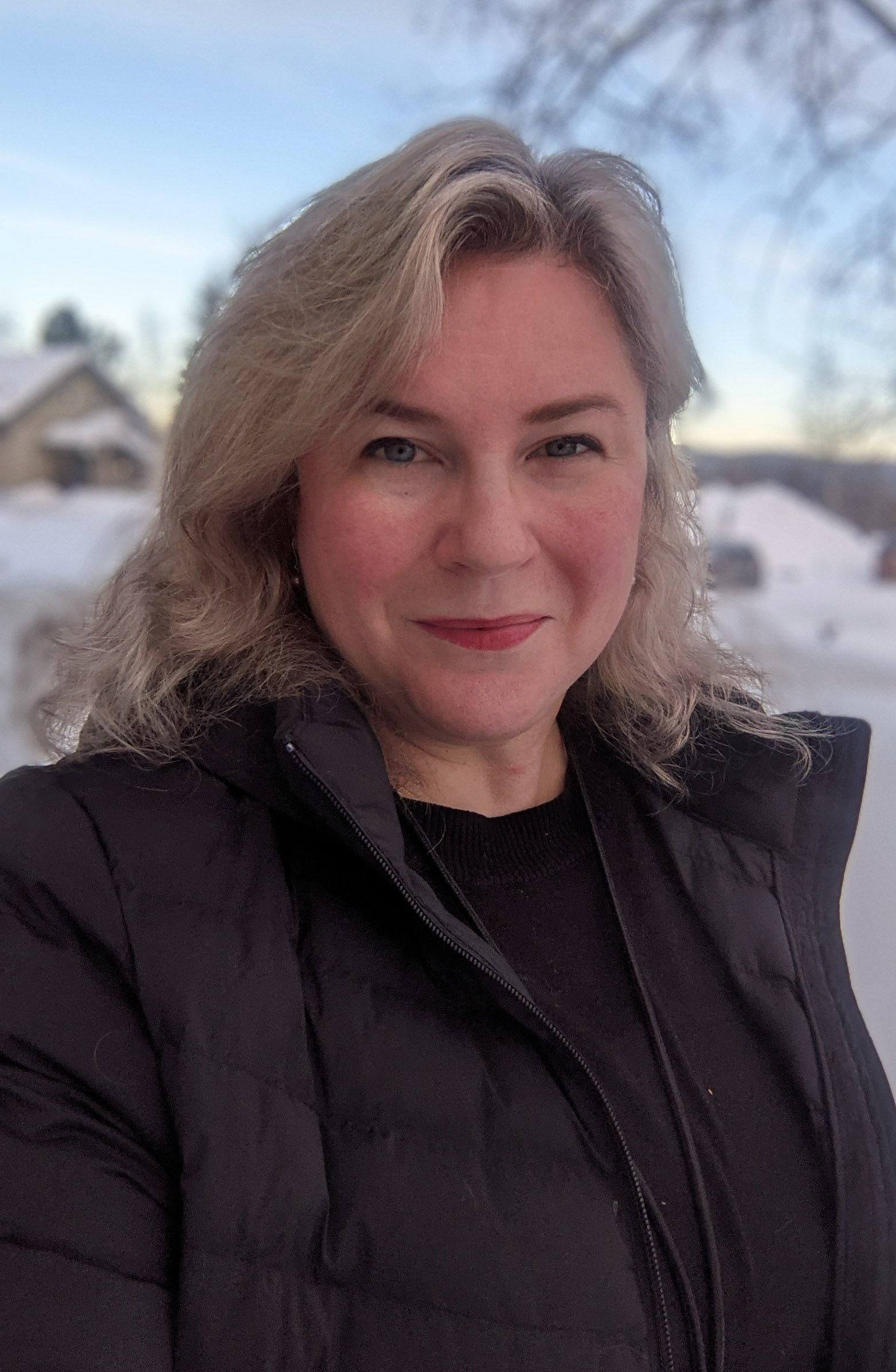 Smiling woman in the snowy outdoors