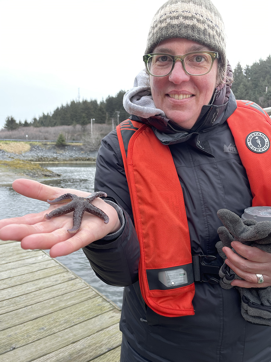 Jenn Wagaman, UAF Extension Service director, holds a sea star in Kodiak, Alaska. 
