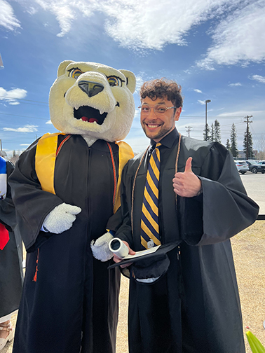 Kyle Augustines, a graphic designer with the UAF University Advancement team, takes a moment to celebrate his graduation with Nook.