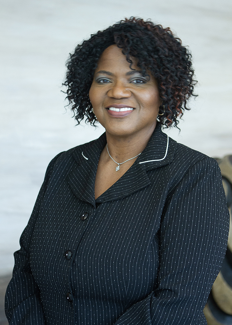 A woman wearing a black blouse with thin white stripes.