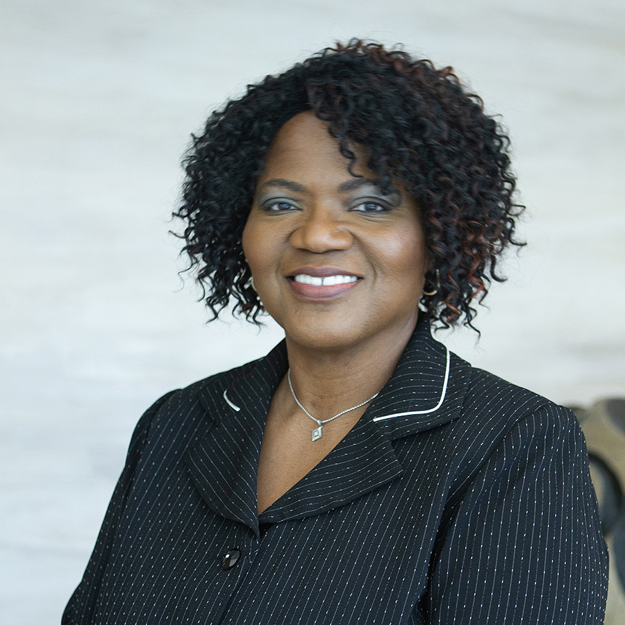 A woman wearing a black blouse with thin white stripes.