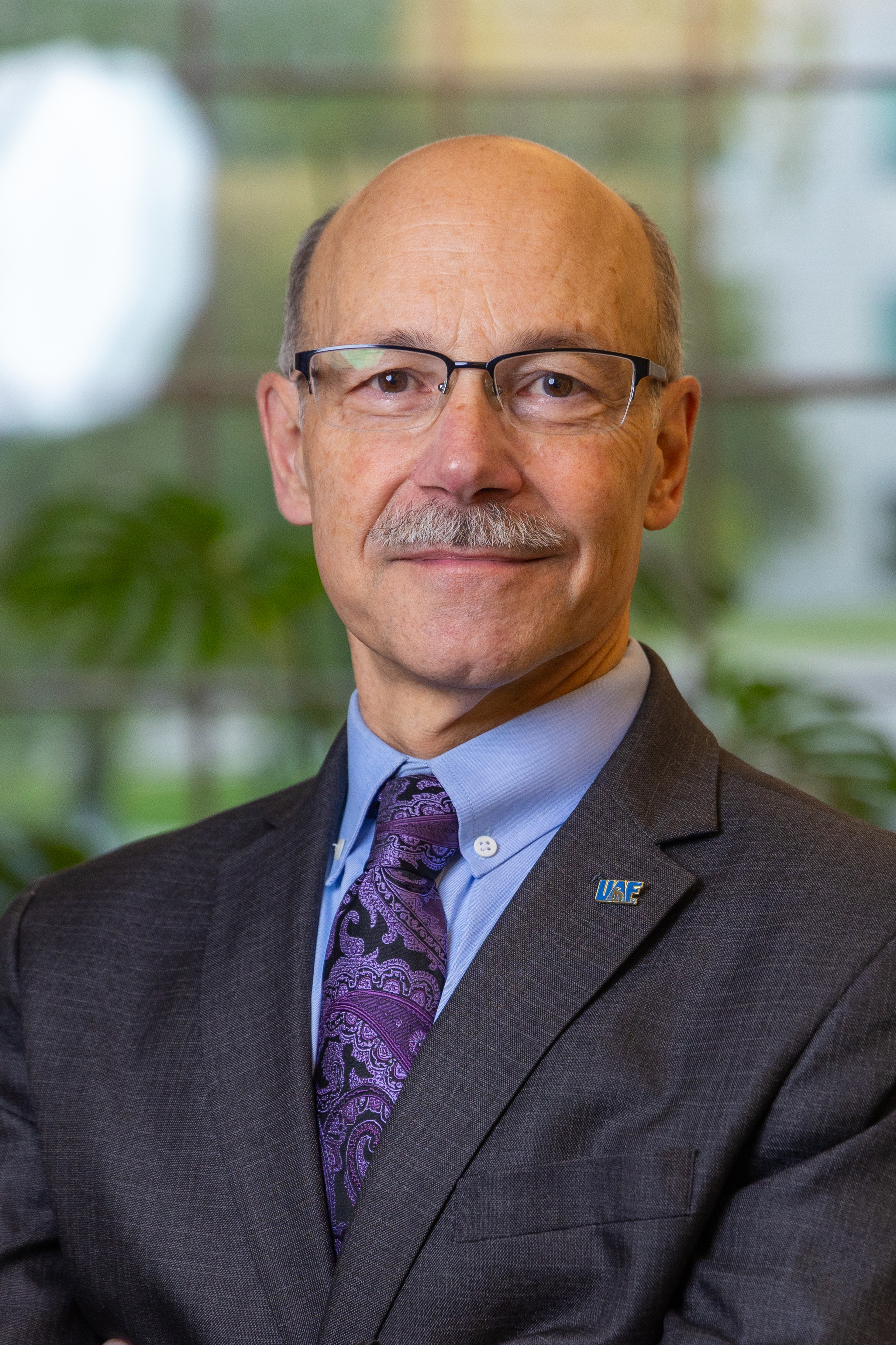 a portrait of a person in a dark suit