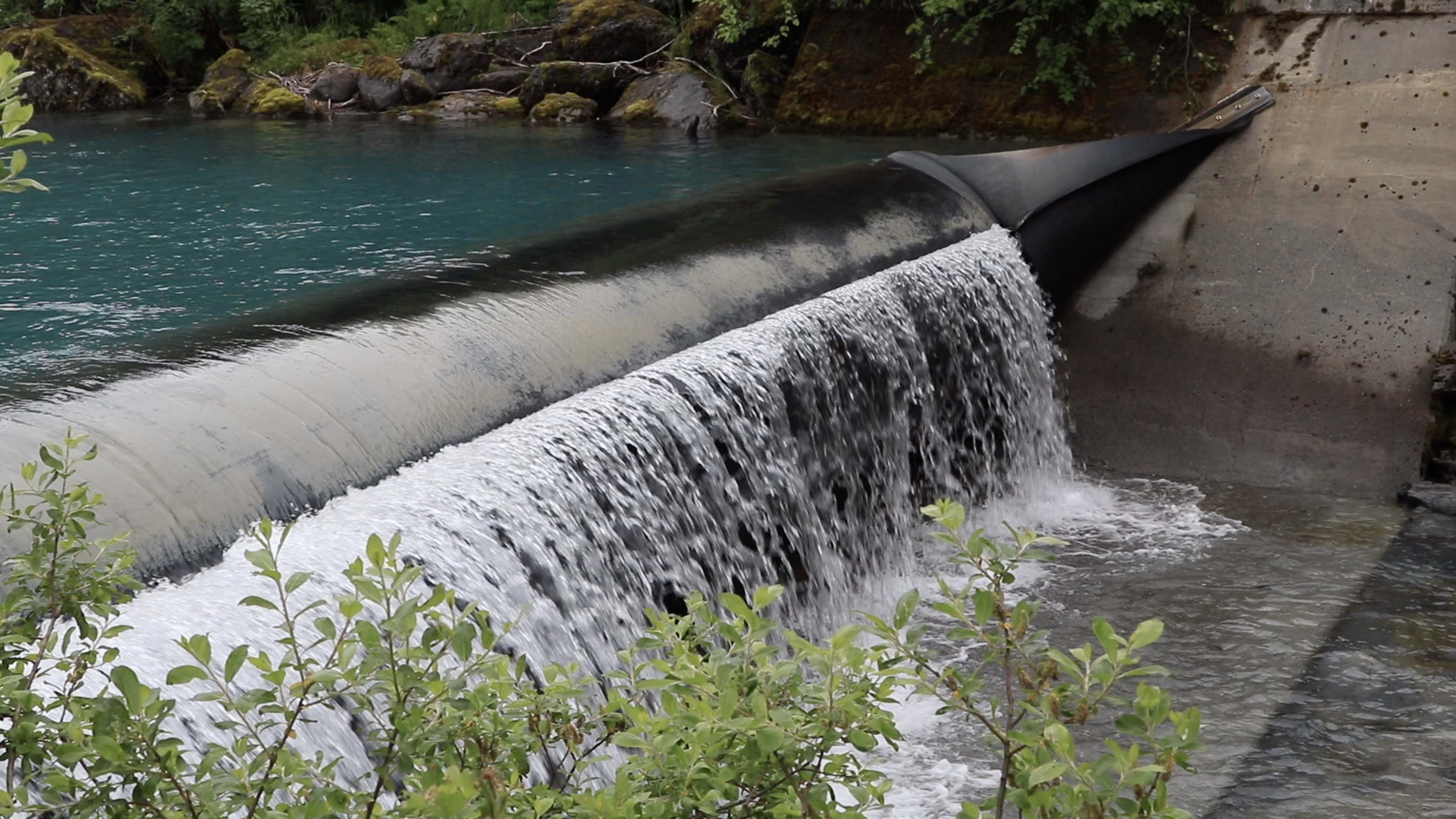 Water flowing over a dam.