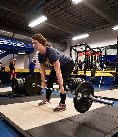 Student performing a Romanian deadlift at the Student Recreation Center.