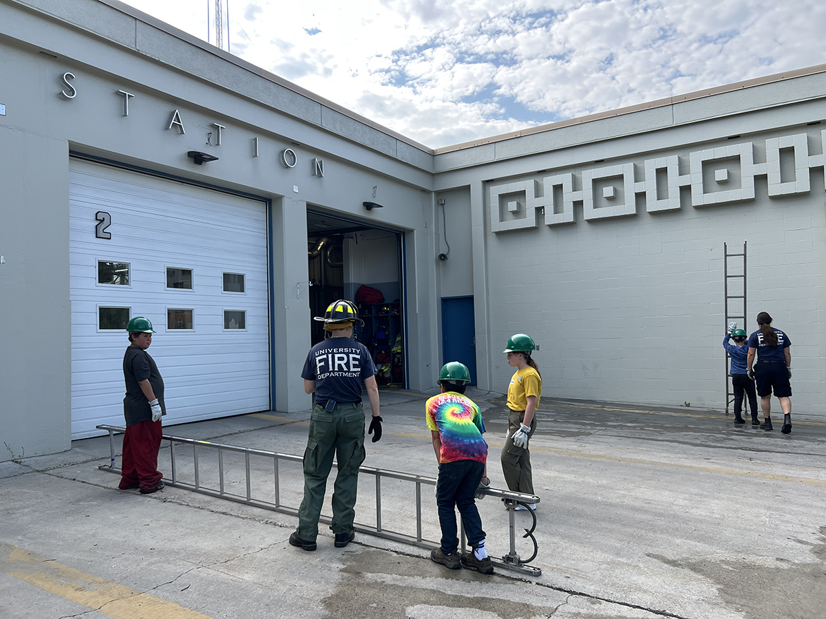 Kids participate in a Summer Sessions Junior Firefighters summer camp with members of the University Fire Department.