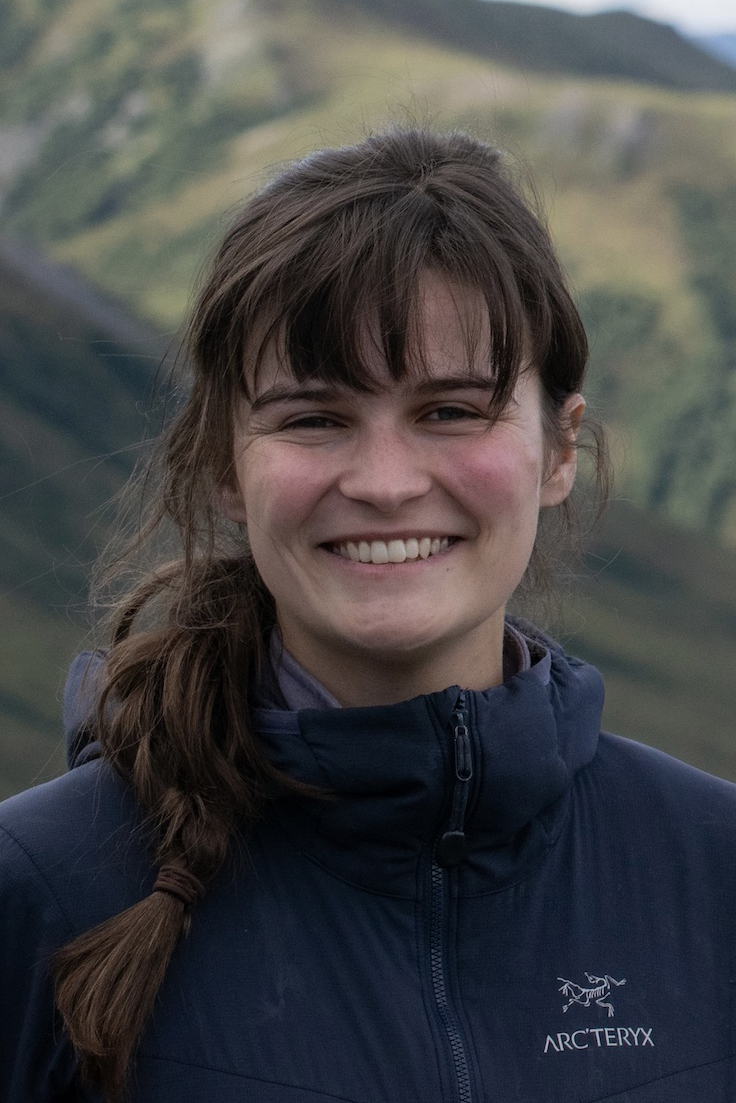 a portrait of a smiling woman with long brown hair