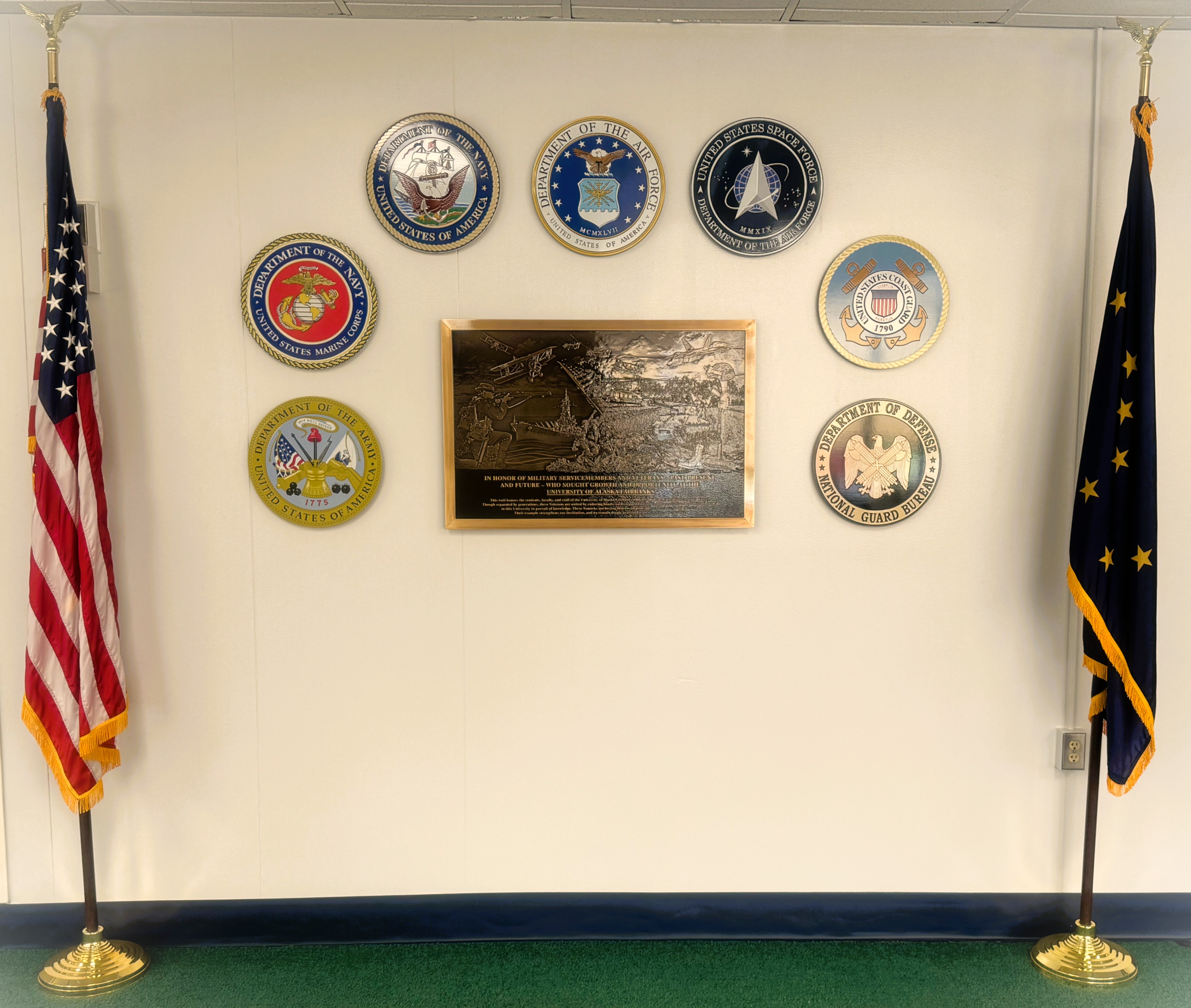 UAF’s veteran monument was unveiled and presented to the institution on July 18, 2025. It is found in Rasmuson 403, adjacent to the Department of Military and Veteran Services.