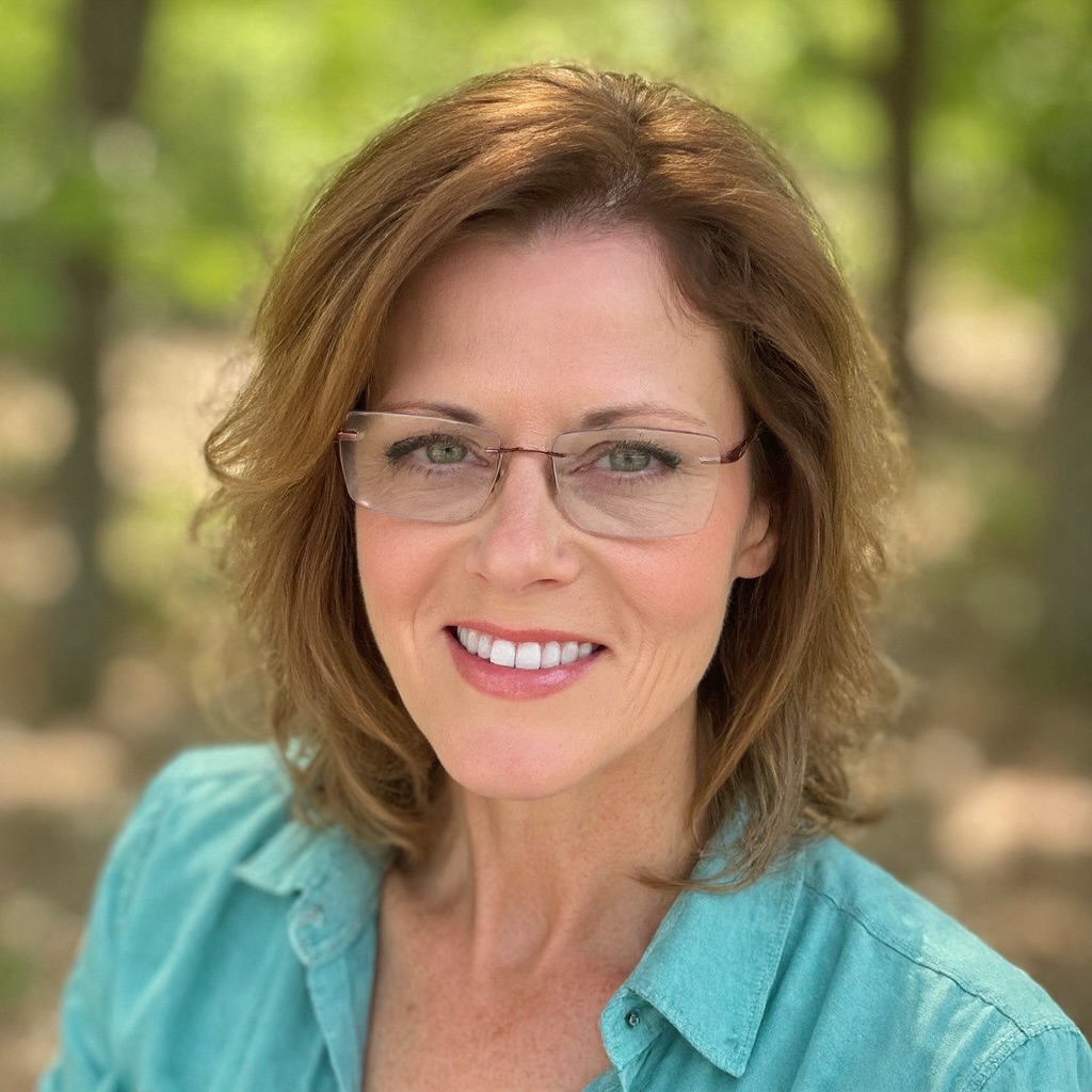 A woman, Winona Benson, poses for a photo with a sunny background