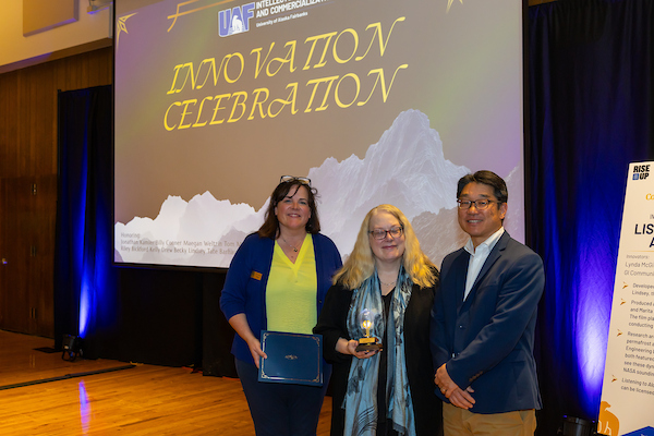 Becky and Lynda accepting their award with David Park