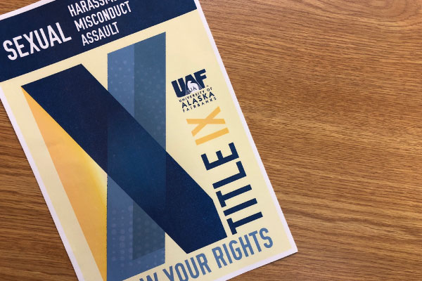 Photo of UAF Title IX brochure on a woodgrain desk