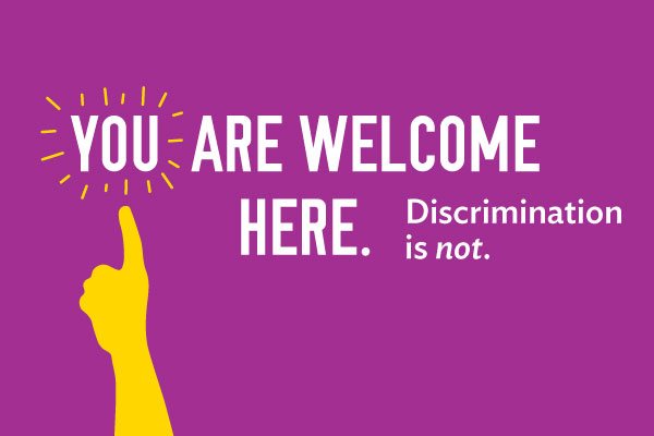 Purple poster that says, You are welcome here. Discrimination is not.