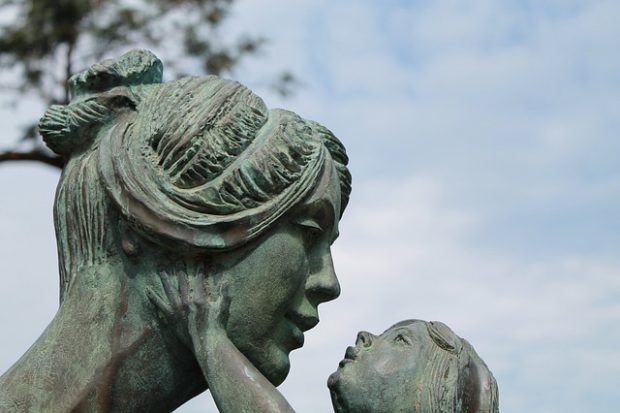 Stone statue of a mother holding a child