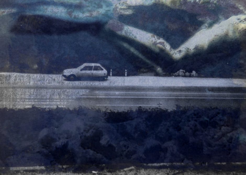 Surreal image in blue of a car on a road | Art by Ana Prundaru