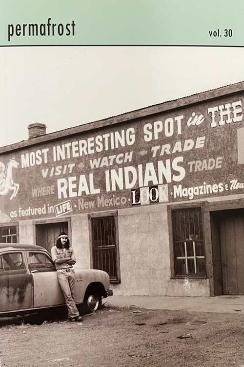 A sepia photo of a man standing in front of a trading post