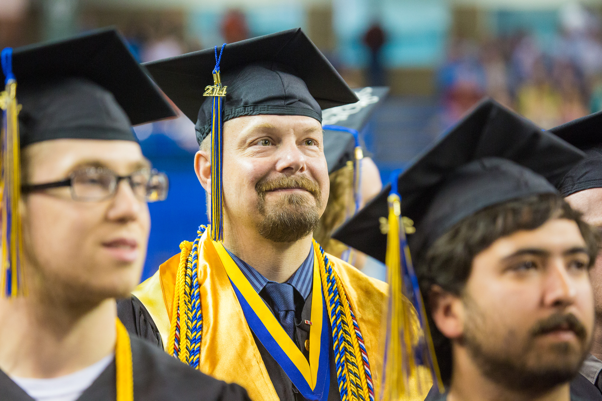 Troy Bouffard is all smiles after returning to his seat during the 2014 Commencement Ceremony Sunday, May 11, 2014 at the Carlson Center. Bouffard received a B.A., in Political Science, cum laude. | UAF Photo by JR Ancheta