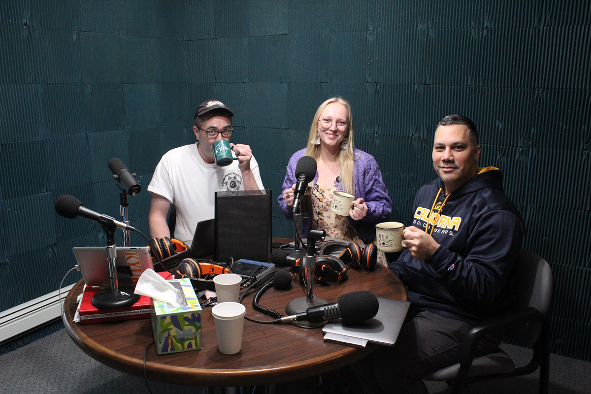 KYUK reporters Evan Erickson (left) and Francisco Martínezcuello (right) sit down with news director Sage Smiley (center) to discuss a few of the newsroom's stories from 2023. Photo credit: Iris Jimmie / KYUK