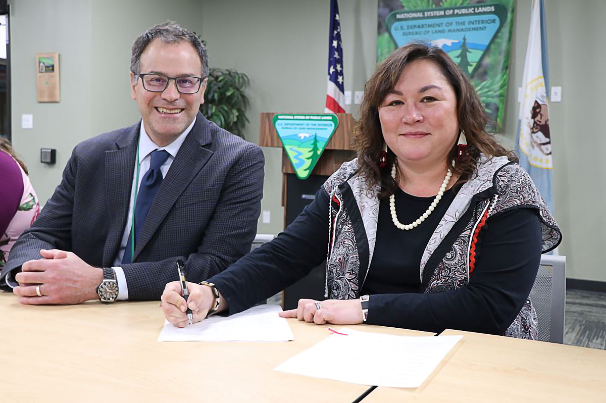 Melanie Bahnke BLM Alaska State Director Steve Cohn (left) looks on as Kawerak, Inc. President Melanie Bahnke (right) signs a new agreement that transfers funds and responsibility for cultural resources program activities on federally managed lands in the Bering Straits Region to Kawerak, Inc. Photo credit: Melinda Bolton (BLM) 2022