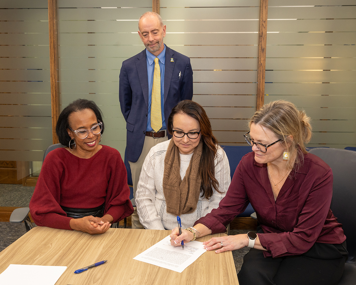 Interim Provost and Executive Vice Chancellor Charlene Stern and Vice Chancellor of Student Affairs and Enrollment Management Owen Guthrie are joined by Mitchell Hamline School of Law President and Dean Camille Davidson, left, and MH partner Michelle Goode for a signing event in the UAF Office of the Chancellor on the UAF campus Thursday morning, October 16, 2025. UAF Photo by Eric Engman
