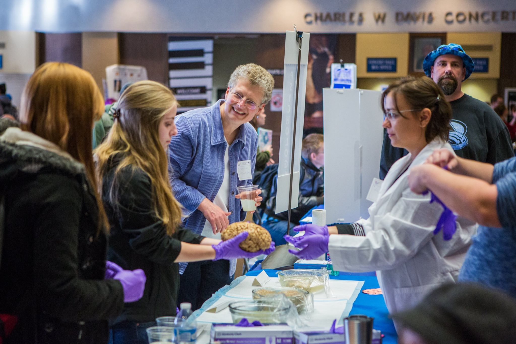 Careers in Psychology Psychology faculty and students pass a brain to a curious onlooker from behind the table at We Are CLA 2016