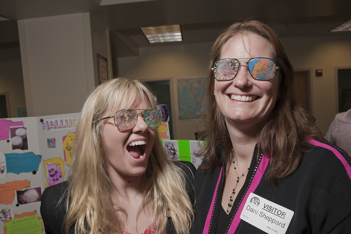 West Valley teacher Joy Grubis, left, and UAF Associate Professor Dani Sheppard show off some cool shades during the Psychology Fair hosted by UAF students and West Valley High School. | UAF Photo by Todd Paris