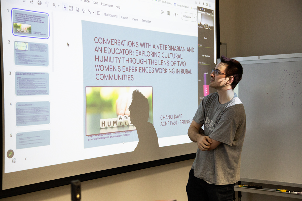 A student examines a presentation in Inna Rivkin's class. UAF Photo by Sarah Manriquez, 2023