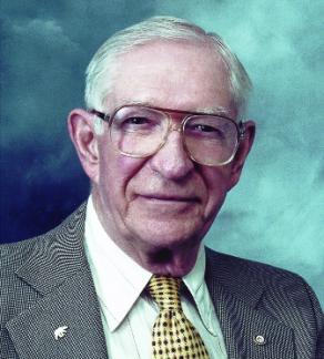 Headshot of Dr. Arthur Buswell on a blue background