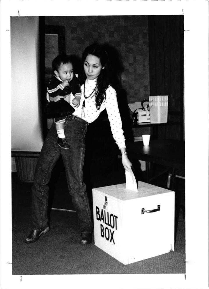 A woman casts a vote in an election held by Doyon Ltd.