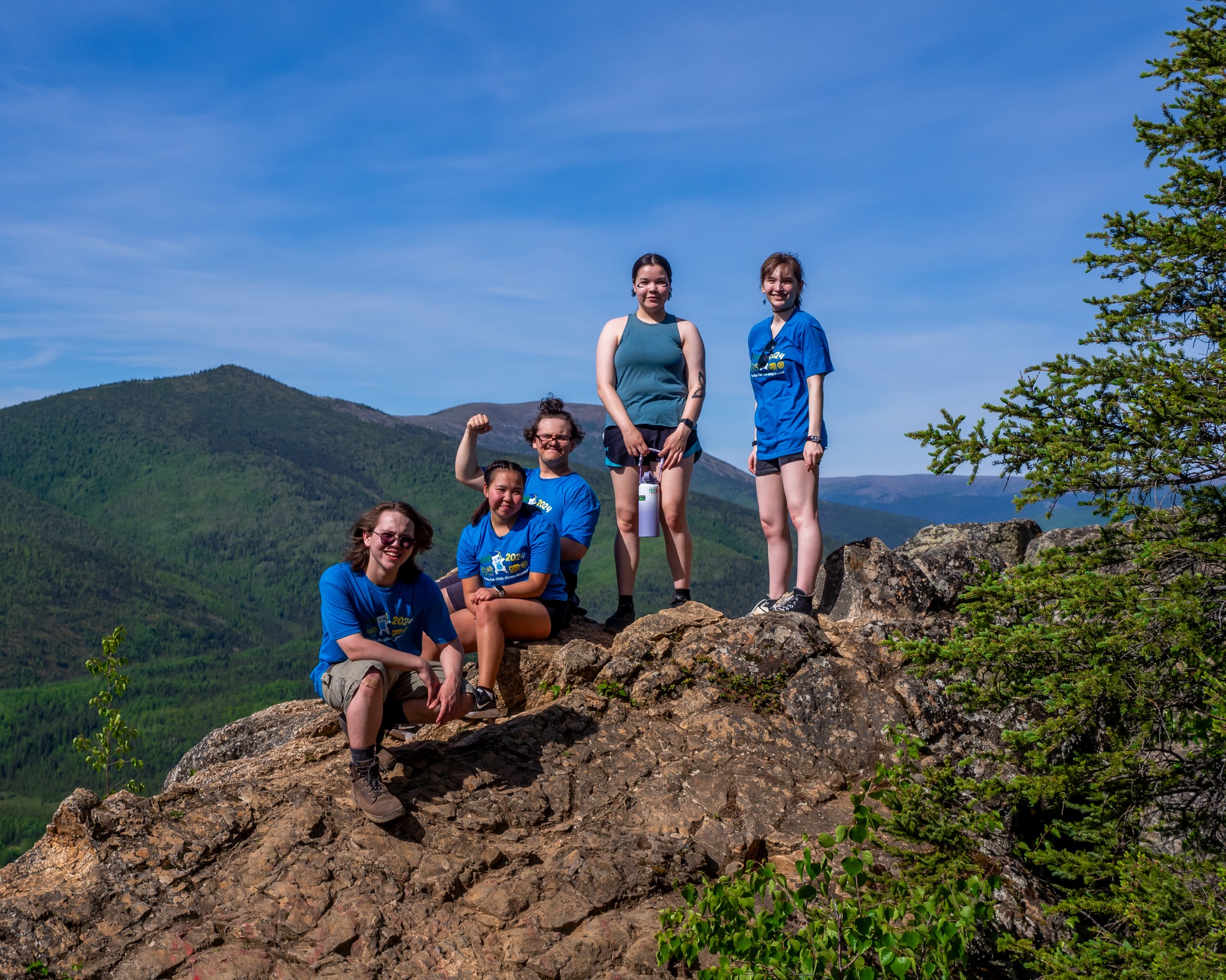 students stand in front of a mountain view