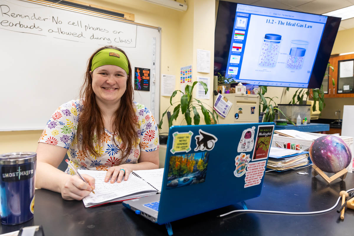 A student teacher smiles for the camera while preparing for her lesson