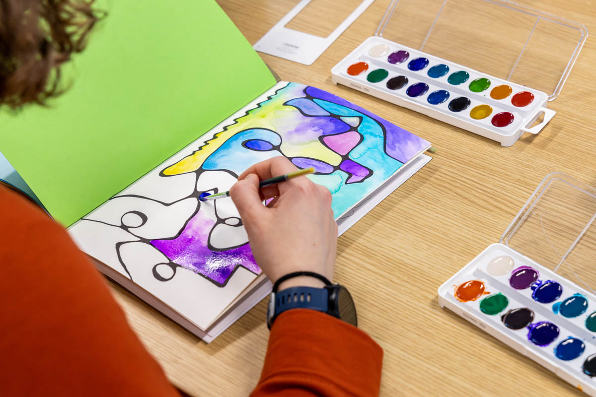 A student makes abstract watercolor art