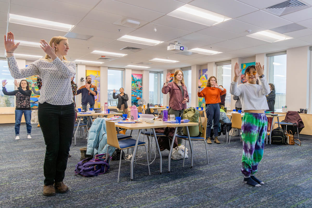Students participate in Alaska Native dancing in a classroom
