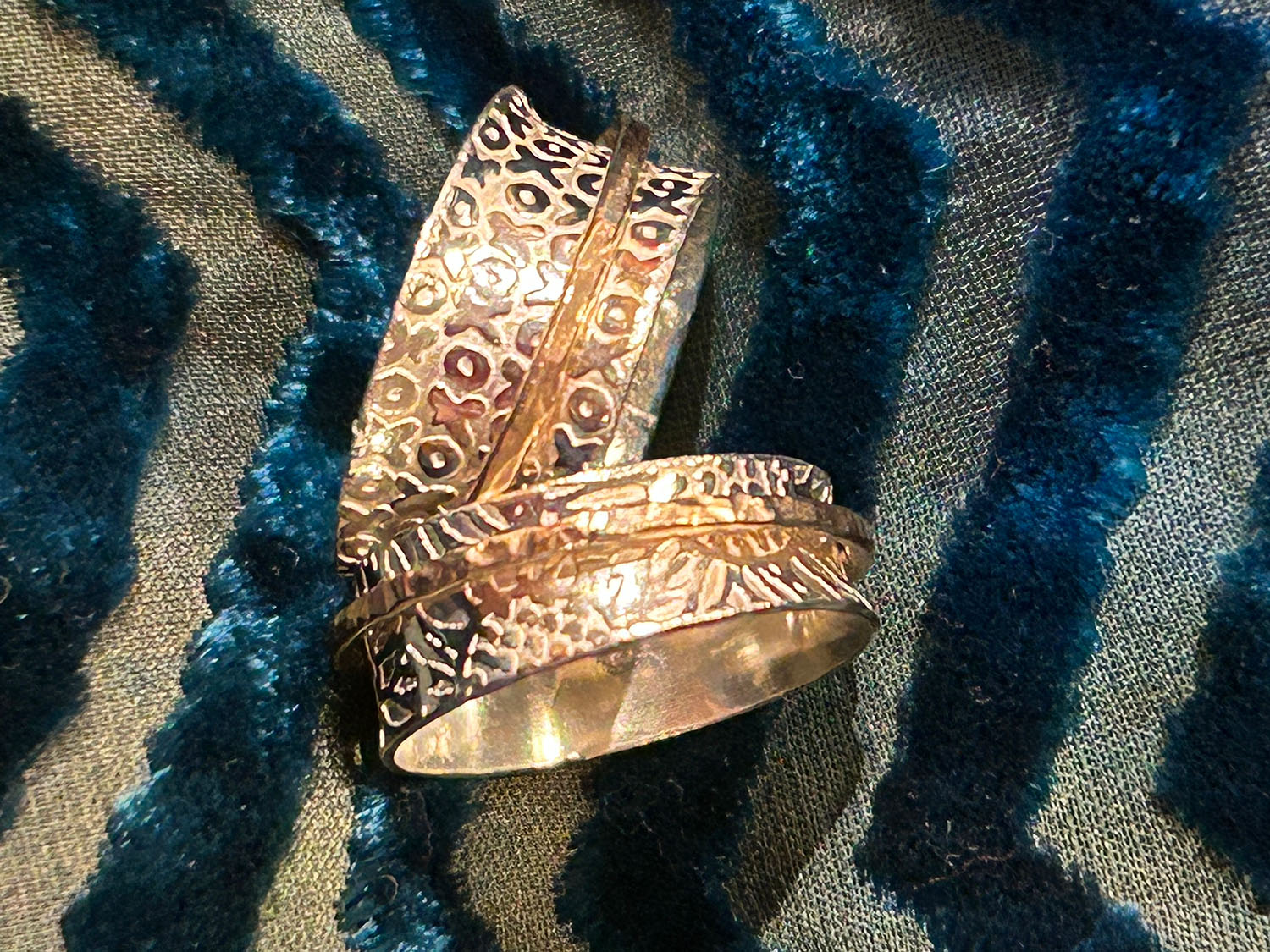 Two rings with an embossed pattern of X's and O's