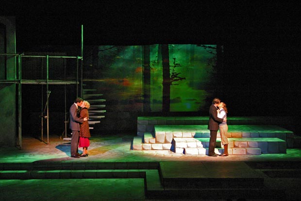 Love shines brightest under the spotlight: Two couples embrace, lost in kisses, center stage.