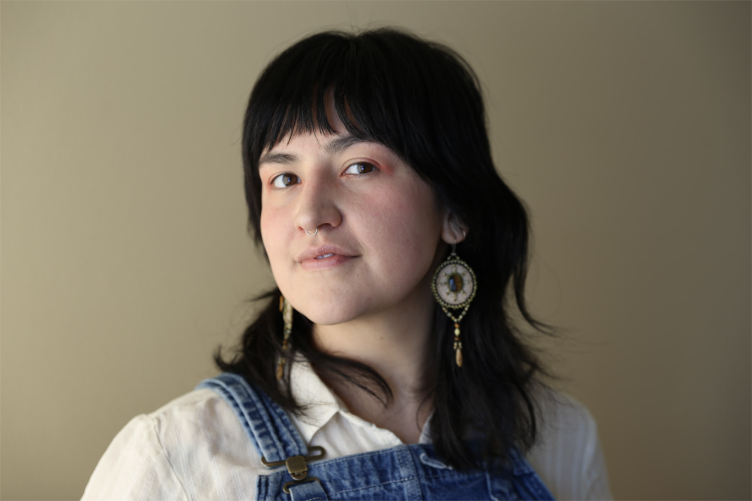 Strange Embrace BTS Crew member from Strange Embrace posing in the window light. UAF Photo by Maya Salganek