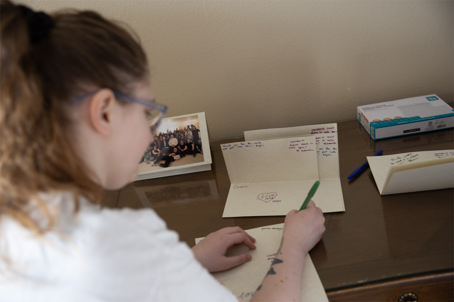 Strange Embrace BTS Cast and crew sign cards on the set of Strange Embrace. UAF Photo by Maya Salganek