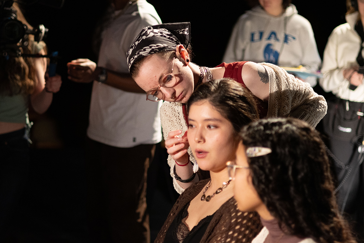 TAOS, Day 1, image 158 Fritz Lutrell fixes Na’ni’eezh Peters' makeup. Photo credit: Eric Marshall