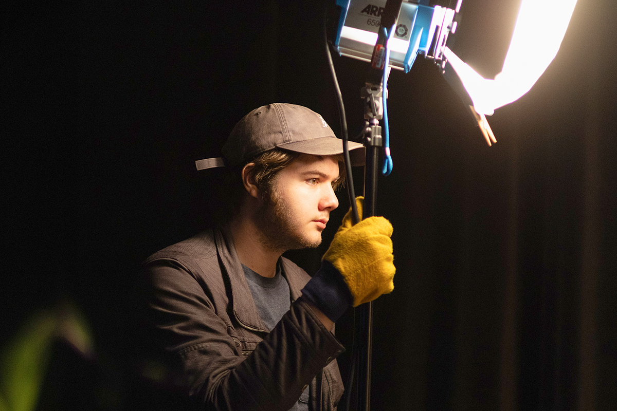 TAOS, Day 2, image 134 Logan Ehrhart stabilizes a light for the set of The Anatomy of Sound. Photo credit: Eric Marshall