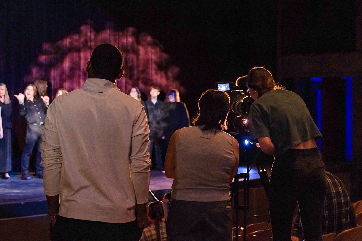 TAOS, Day 2, image 53 Camera crew Dre Williams, JB Brown and Chloe Miller film the choir onstage. Photo credit: Eric Marshall