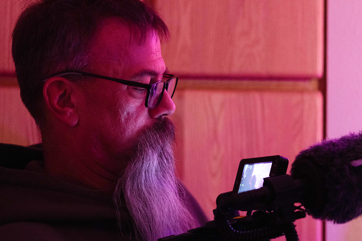 TAOS, Day 4, image 81 Roscoe Archer watches the scene unfold through the back of his camera on the set of The Anatomy of Sound. Photo credit: Eric Marshall