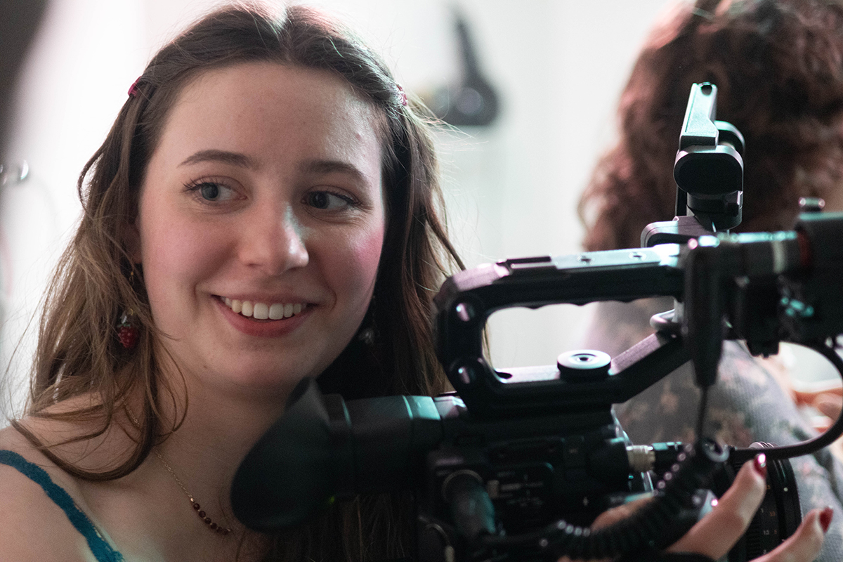 TAOS, Day 5, image 144 Chloe Miller smiles behind the camera on the set of The Anatomy of Sound. Photo credit: Eric Marshall